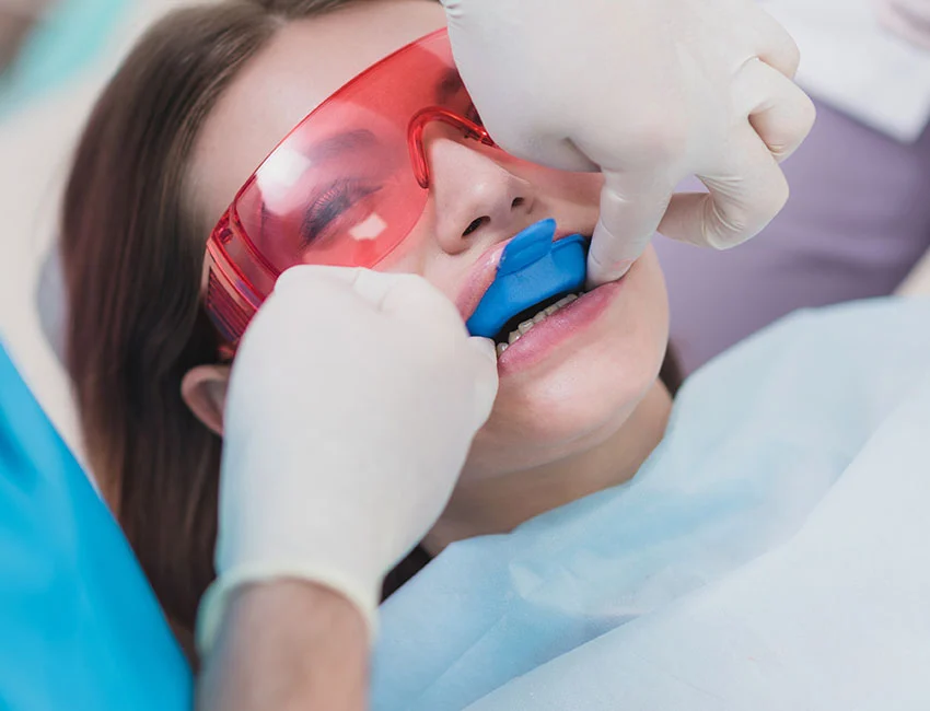 Patient getting fluoride treatment at dental office